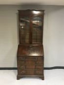 A mahogany bureau bookcase on bracket feet