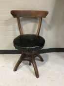 An early twentieth century swivel adjustable desk chair