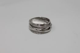 An Al Coro Serenata 18ct white gold multi-shank diamond encrusted crossover ring, size O/P, 10.
