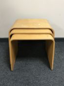 A nest of three beech tables