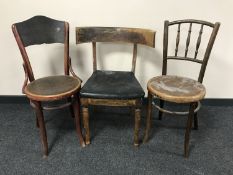 An antique oak elbow chair together with two bentwood chairs