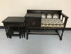 An oak telephone table together with a nest of three oak tables