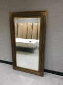 A decorative gilt framed overmantel mirror