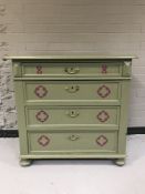 An early twentieth century painted pine four drawer chest on bun feet