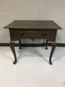 A Georgian oak side table on Queen Anne style legs fitted with a drawer
