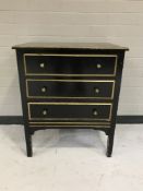 A painted pine three drawer chest
