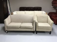 A two seater late twentieth century settee upholstered in brown fabric together with similar