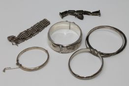 A collection of silver bangles and bracelets