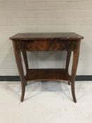 A mahogany two tier side table fitted with a drawer