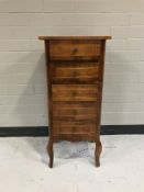 A narrow inlaid mahogany five drawer chest