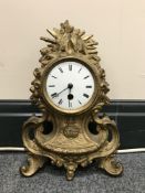 An early 20th century French gilt mantel clock with enamelled dial