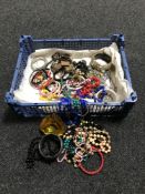 A basket containing a quantity of costume jewellery including bracelets,