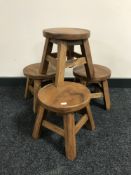 A set of four contemporary milking stools
