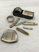 A silver napkin ring in case, together with 5 pen knives,