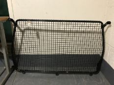 A metal car partition grill
