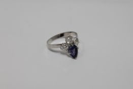 A pear-cut tanzanite and three stone diamond ring
