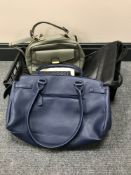 A basket containing three leather ladies handbags including Bulaggi Fiorelli,