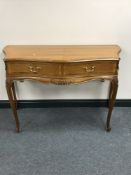 A 20th century inlaid mahogany continental serpentine fronted side table fitted two drawers