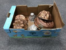 A box containing vintage copper and metal jelly moulds