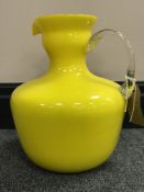 A 1950's Italian Empoli yellow Murano cased glass pitcher with twisted handle, height 24 cm.