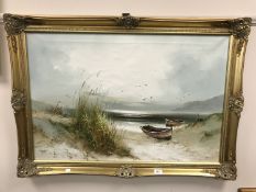 A gilt framed oil on canvas depicting rowing boats on a shoreline signed by J.
