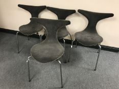 A set of four 1970's shaped stacking dining chairs on chrome legs