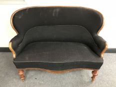 An antique mahogany framed serpentine fronted settee in black fabric