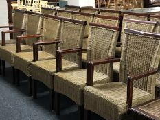 A set of twenty two wood framed, wicker armchairs *This lot is subject to VAT at the current rate.
