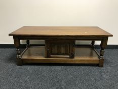 A Priory oak coffee table fitted a cupboard