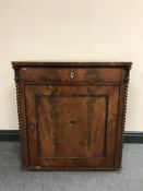 A late 19th century mahogany cupboard fitted a drawer