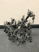 A black glass and metal eight branch chandelier with glass drops