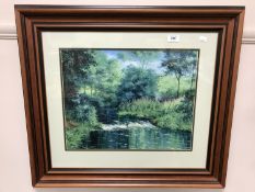 An oil depicting a river running through a wooded landscape, signed J.C Madgin, dated 1985.