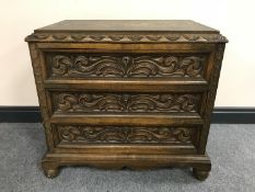 An early 20th century carved oak three drawer chest CONDITION REPORT: 65cm high,