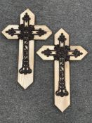 A set of six cast metal crosses mounted on boards