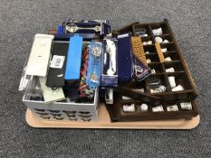 A tray consisting of a collection of crested tea spoons and china thimbles