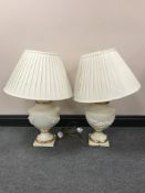 A pair of contemporary cream and gilt table lamps with shades