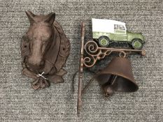 A cast metal horse head and a metal bell 