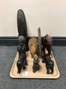 A tray of carved hardwood tribal figures,