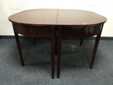 An early 19th century mahogany D-end extending dining table