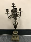 An antique brass and onyx five way table candelabrum