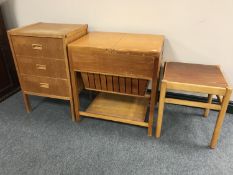 A 20th century teak sewing trolley teak three drawer chest and side table