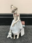A Lladro figure, girl seated on telephone,