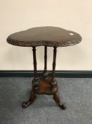 A nineteenth century mahogany pedestal clover leaf table