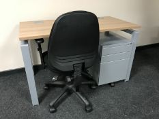 A contemporary office desk on metal legs,