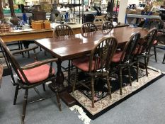 An oak refectory dining table and eight wheel back chairs