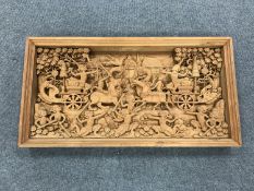 An early 20th century carved Eastern panel, profusely carved with figures in battle,