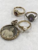 A 9ct gold garnet set ring, together with two 9ct gold dress rings and an antique locket.
