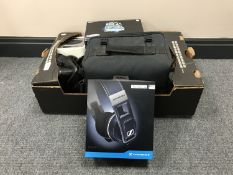 A box containing Samsung video camera, a pair of boxed Sennheiser headphones,