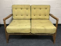 A mid 20th century teak framed two seater settee