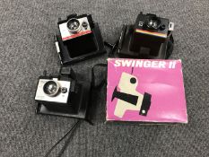 A basket containing four polaroid cameras (one boxed)